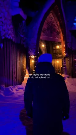 Couple enjoying winter magic in Lapland, Finland with snowy trees and festive vibes. #VisitLapland #Rovaniemi