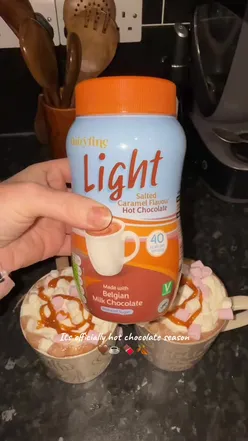 'Aldi hot chocolate topped with whipped cream and marshmallows, perfect for cozy winter days #aldi #hotchocolateseason'