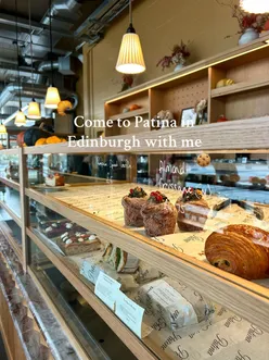 Enjoying pastries at a cozy cafe just outside Edinburgh, including almond croissants and cinnamon buns.