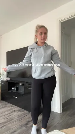 Group of friends enjoying drinks and snacks at a lively bar, sharing laughs and capturing moments on their phones.