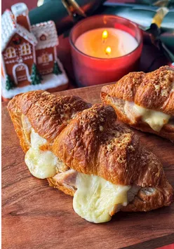 Festive Turkey & Brie Croissant Melt served with cranberry sauce, ideal for transforming Christmas leftovers into a delicious meal.