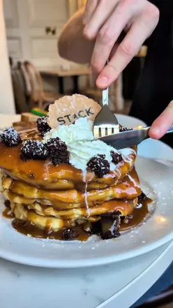 Delicious all-day breakfast at STACK Newcastle, featuring Full English and Shakshuka Eggs with pancakes and lattes.