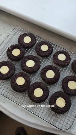 Delicious chocolate Guinness cookies with fudgey texture and white chocolate bits, perfect for dessert lovers.