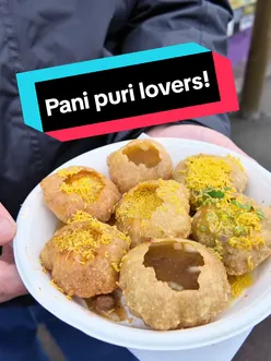 Delicious pani puri served at an Indian street food stall in Leicester, perfect for adventurous food lovers.