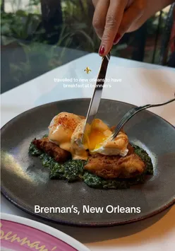 Breakfast at Brennan's in New Orleans featuring crab cakes, Eggs Hussarde, and iconic Bananas Foster.
