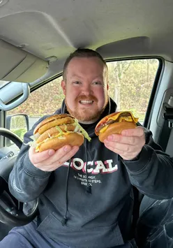 Jas reviewing McDonald's secret menu items at the drive-thru, featuring burgers, chilli cheese bites, and scores.