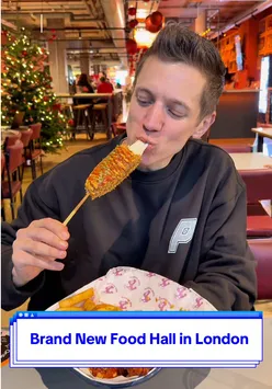 Visitors enjoying diverse cuisine at the new food hall in Tower Bridge Collective, London.