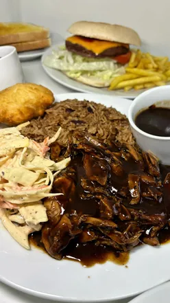 Delicious British and Caribbean dishes at Marie's Deli in Ashton Under Lyne, featuring hearty breakfasts and vibrant jerk chicken.