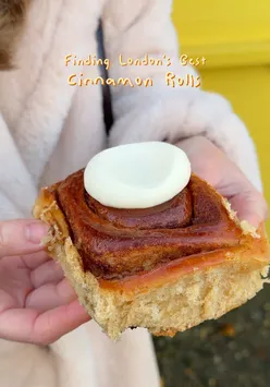 Sampling delicious cinnamon rolls at a bakery in London while searching for the city's best treats.