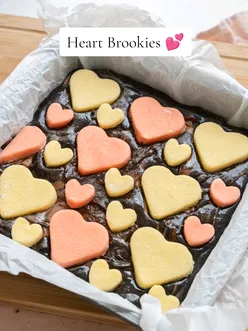 Delicious heart-shaped cookies on a baking tray, perfect for Valentine's Day treats.