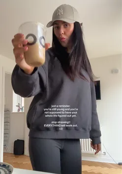 'A person enjoying iced coffee and celebrating small victories, radiating positivity and self-love.'