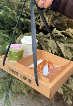 Delicious pastries lined up at a Paris café, tempting visitors with their sweet aroma and charming presentation.