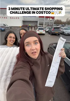Participants racing through Costco for a 3-minute shopping challenge with carts full of groceries.