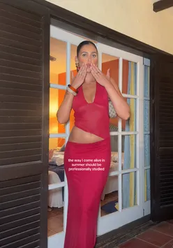 Young person enjoying summer vibes in trendy outfit, showcasing tanned skin against a vibrant background.