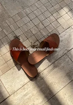 Person checking email on a phone, with a humorous expression, at Hemingways Nairobi during a solo trip.