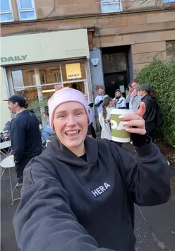 Content creator enjoying coffee and charity support before a half marathon in Glasgow.