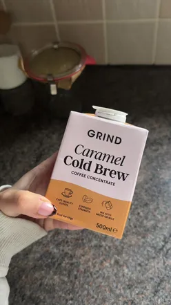Homemade iced coffee hack with strong brew and sweetener, featuring Grind caramel cold brew coffee.