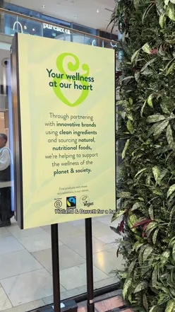 User showcasing a Holland & Barrett haul featuring vegan snacks, vitamins, and natural beauty products.