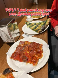 Delicious pizza slice at Vincenzo’s in Shoreditch, with enthusiastic diners planning their next visit.