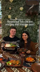 A couple visits Bali Satay House in Barnet, London, providing a review of the Indonesian restaurant. The video features shots of the traditional interior, the menu, and a variety of dishes including chicken satay, chicken rendang, and banana fritters, highlighting the authentic experience and spicy flavours.