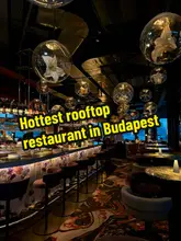 A short, stylish video showcasing a visit to Bibo in Budapest. The creator is shown arriving at the venue, enjoying the rooftop views, listening to the DJ, and sampling various Spanish-Hungarian fusion dishes and cocktails.
