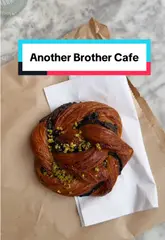 A short, aesthetic montage showcasing the interior, coffee machine, menu, and pastry selection of a local cafe called Another Brother.