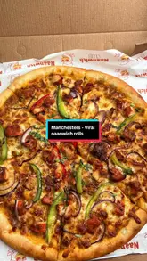 Loaded tandoori chicken naanwich rolls and a fusion butter chicken pizza with melty cheese from Naanwich Club, Manchester.