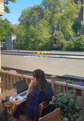 A short, aesthetic vlog capturing a solo visit to Saphi cafe in London. The video features close-ups of a matcha latte and a matcha cookie, shots of the menu board and pastry display, and glimpses of the cafe's terrace and interior seating area.