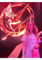 The video follows a creator getting ready for and attending The Hunger Games: On Stage in London. It features outfit selection, a tour of the venue's interior, the merchandise area, the bar, and clips from the stage performance.