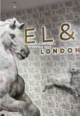 A short, fast-paced montage showcasing the interior and food offerings of EL&N London, a highly aesthetic cafe. The video features quick cuts of various cakes, pastries, and sandwiches, alongside shots of the venue's signature carousel horse decor.