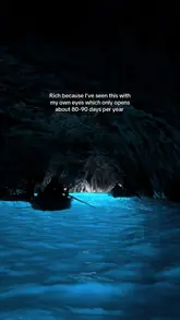 A short, first-person travel reel showcasing a boat trip into the Blue Grotto in Capri, Italy. The video highlights the glowing blue water and the experience of touching the water inside the cave.