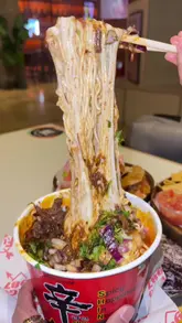 A food review video showcasing birria ramen, tacos, and nachos at Fuego 1987, located within the Tower Bridge Collective food hall. The video features close-up shots of the food, including a cheese pull, and provides a positive review of the dishes.