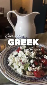 A short-form video review of a Greek restaurant in London, featuring a variety of dishes including dips, salads, souvlaki, and dessert. The video uses a voiceover to describe the food and atmosphere, with shots of the table spread and the venue's interior and exterior.