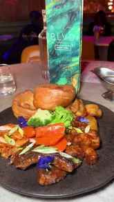A promotional reel for BLVD in Manchester, highlighting their Sunday roast offerings, including traditional and Caribbean-inspired options, alongside cocktails and desserts in a stylish venue setting.