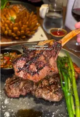 A creator visits Three Flames Steakhouse in Wakefield, showcasing the dry-aged meat selection, the restaurant interior, and various dishes including steak, lamb chops, and cheesecake.