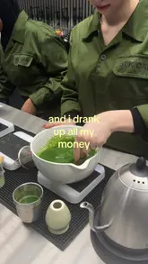 A short, aesthetic video showcasing the preparation of a matcha latte at a cafe called BLK CAB, focusing on the whisking and pouring process.