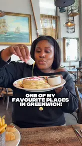 A personal and inviting vlog-style review of River Gardens Cafe in Greenwich, featuring a lunch visit with the creator's father. The video highlights a variety of dishes including chicken skewers, fish and chips, a superfood salad, pancakes, and sticky toffee pudding, while also addressing a local issue regarding scaffolding that makes the venue appear closed.