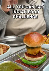 A creator visits Papa Dum in London to take on their 'Unlimited Indian Street Food Challenge'. The video features a variety of dishes including samosas, vada pav, pakora, and various chicken and paneer plates, all while explaining the rules of the challenge.
