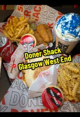 A vlog-style review of Doner Shack in Glasgow, featuring the creator trying various menu items including a halloumi kebab, chicken tenders, crinkle-cut chips, and an Irn-Bru milkshake.