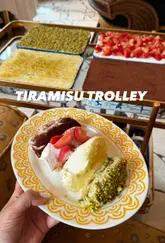 A vibrant reel showcasing a unique tiramisu trolley at Barbarella, part of the Big Mamma group. The video highlights four different tiramisu flavours—classic, strawberry, lemon, and pistachio—while also providing glimpses of the restaurant's interior, starters, pasta, and pizza, effectively positioning the venue as a desirable spot for a weekend meal.