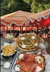 A promotional reel for Common Pizza in Clapham Common, showcasing their dual offering of NYC-style and Detroit-style deep-dish pizzas, alongside cocktails and a lively outdoor atmosphere with a DJ.