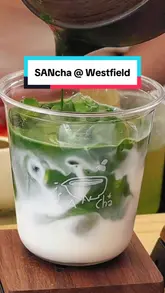 A short, aesthetic video showcasing the preparation of a matcha latte at SANcha, located within a shopping centre. The video features close-up shots of the whisking and pouring process, highlighting the vibrant green colour of the matcha.